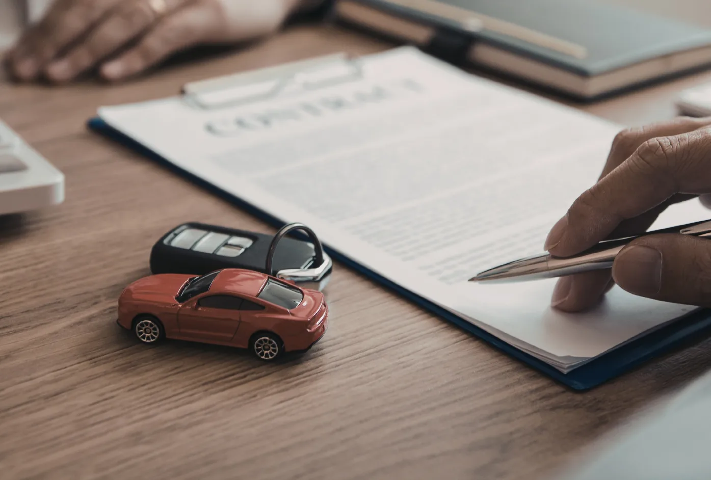 toy car, car keys and insurance paperwork