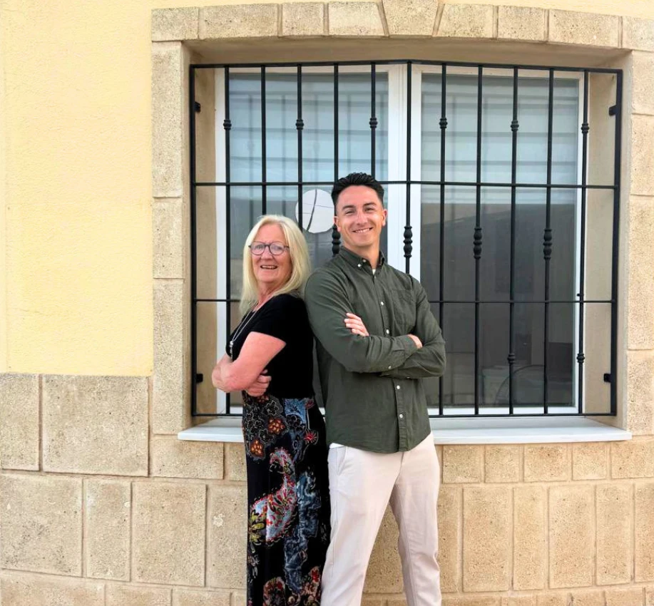 Thomas and Maria at Dragon Insurance standing back-to-back